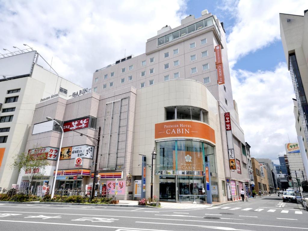 a large building on a street in a city at Premier Hotel Cabin Matsumoto in Matsumoto