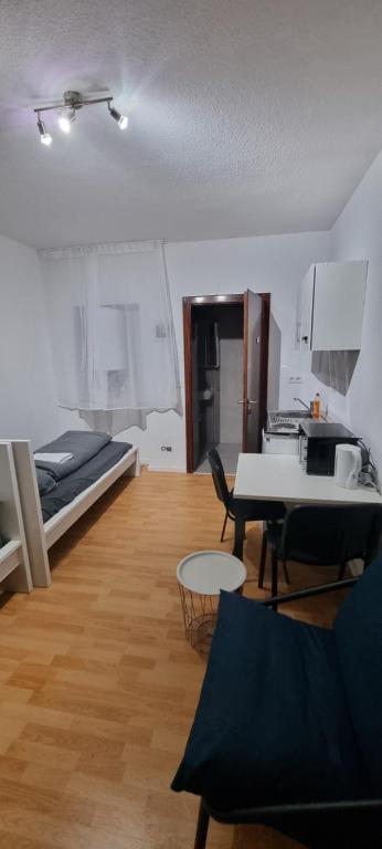 a room with a bed and a table and a kitchen at Book your Appartment in Darmstadt City in Darmstadt