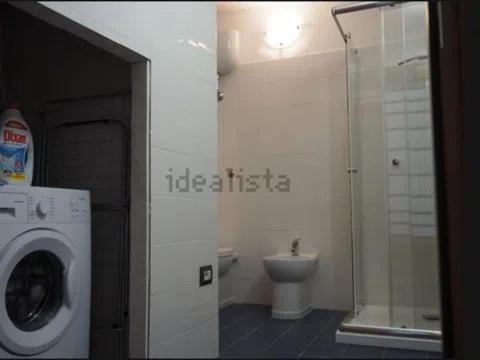 a bathroom with a washing machine and a toilet at TreDomus in Iglesias