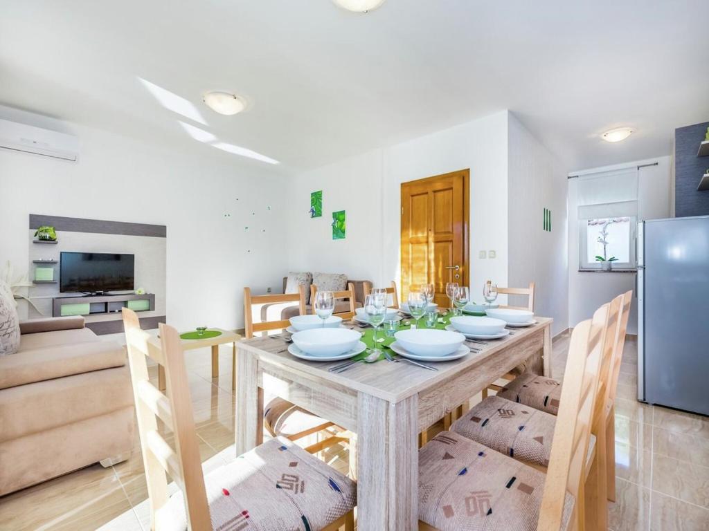 a kitchen and dining room with a table and chairs at Contemporary Holiday Home in Dramalj with Swimming Pool in Dramalj
