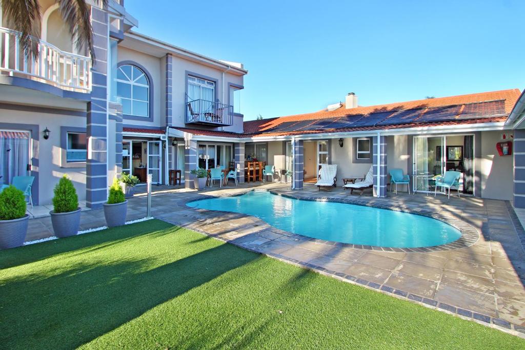 a swimming pool in the backyard of a house at Atlantic Beach Villa in Cape Town