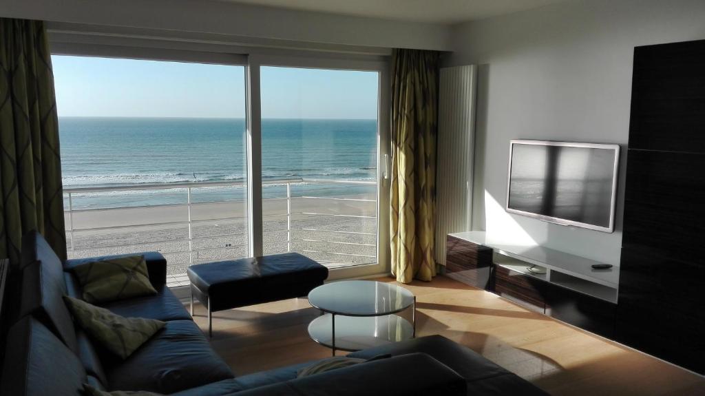 a living room with a view of the ocean at Splendid 0705 in De Panne