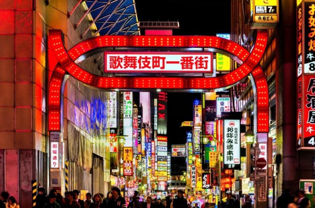 a crowd of people walking down a city street at night at Alo BnB 4 - Near KABUKICHO, SHINJUKU, SHINOKUBO, SHIBUYA - Self check-in in Tokyo
