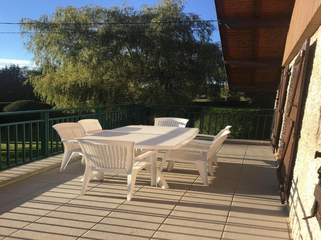 a white table and chairs on a patio at Elegant Chalet in Gerbépal in cosy environment in Gerbépal