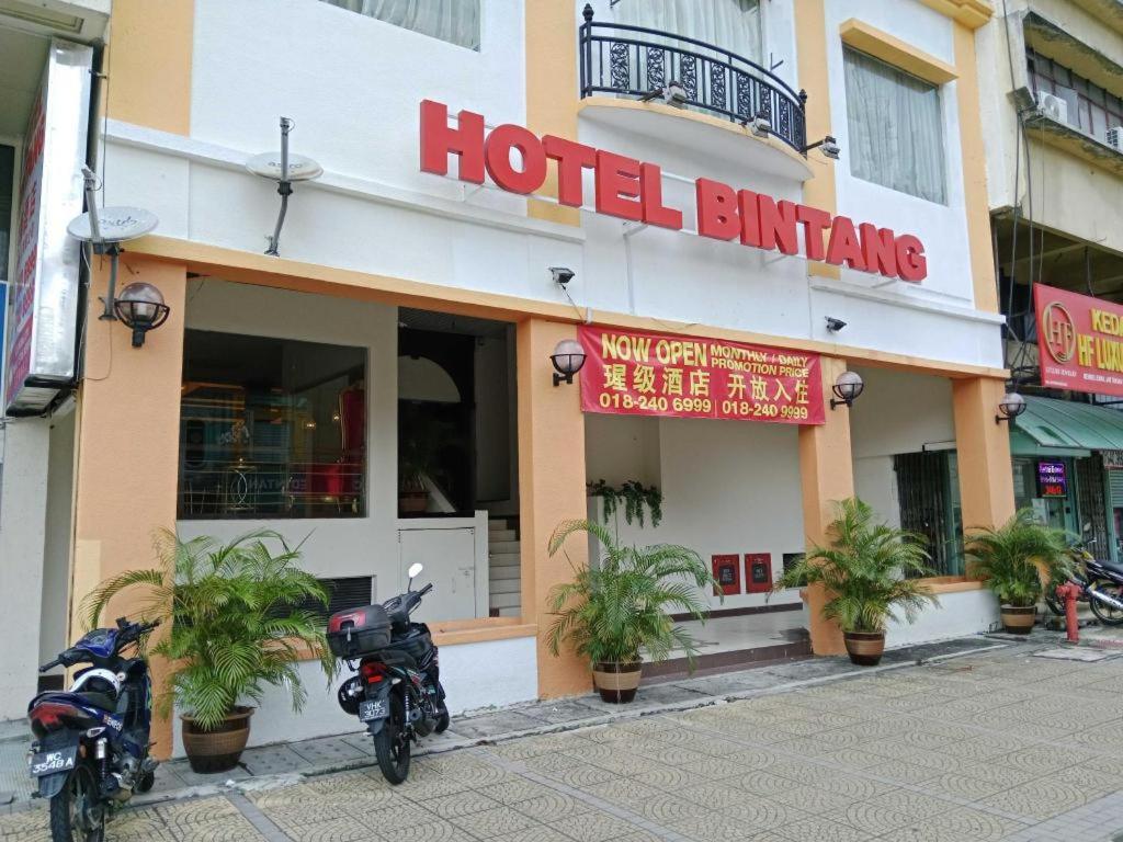two motorcycles parked in front of a hotel building at Hotel O Bintang Holiday in Kuala Lumpur