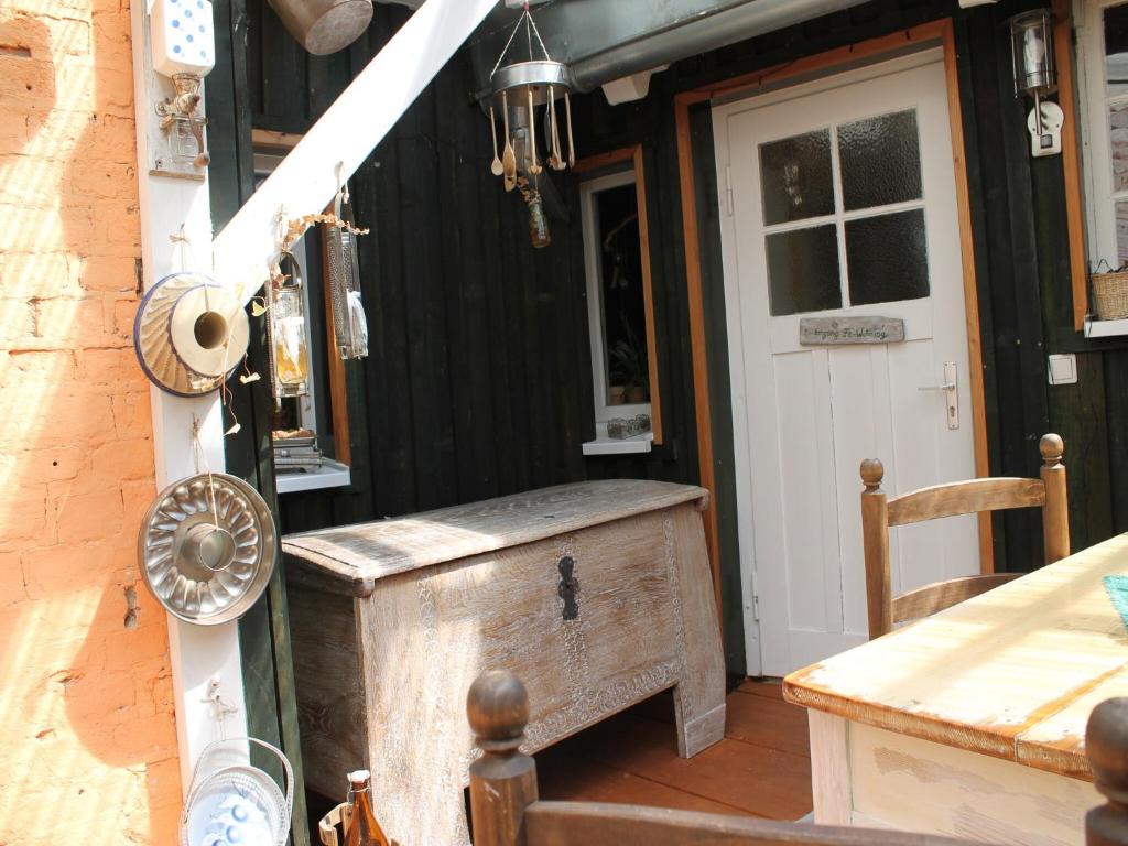 a wooden chest sitting on the porch of a house at Beautiful Apartment in Damgarten with Garden in Ribnitz-Damgarten