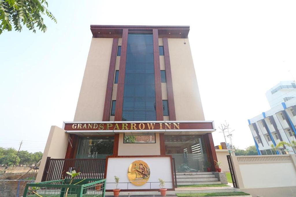 a building with a sign in front of it at HOTEL GRAND SPARROW Inn in Agra