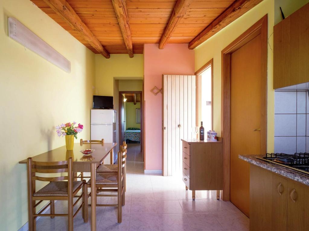a kitchen with a table and chairs in a room at Holiday Home in Sciacca with Garden, Swimming Pool, Parking in Cartabubbo