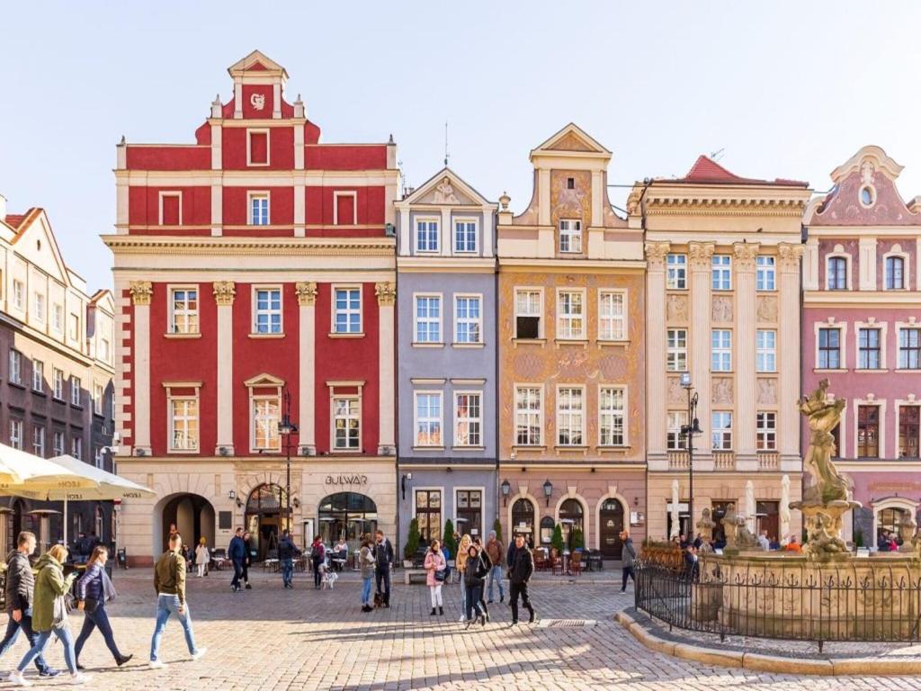 a group of people walking in front of buildings at Holiday House in Szczecin at the lake with parking space for 4 persons in Szczecin