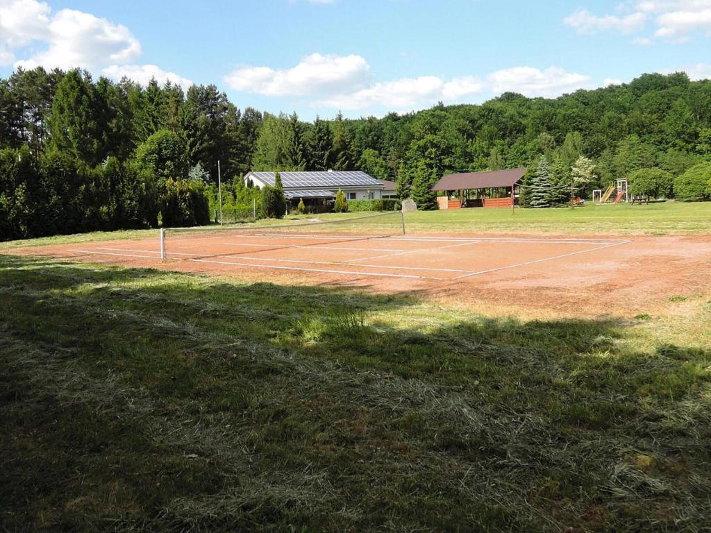 a tennis court in the middle of a field at Holiday House in Szczecin at the lake with parking space for 4 persons in Szczecin