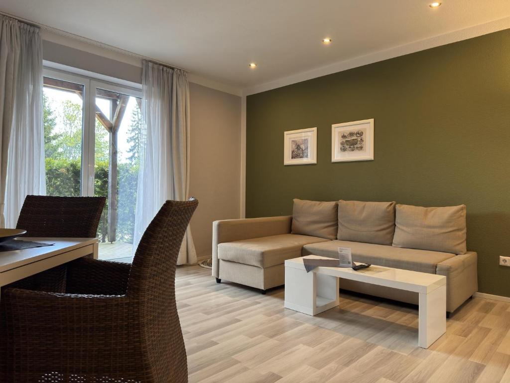 a living room with a couch and a table at Appartementhaus in Drei Annen Hohne in Drei Annen Hohne