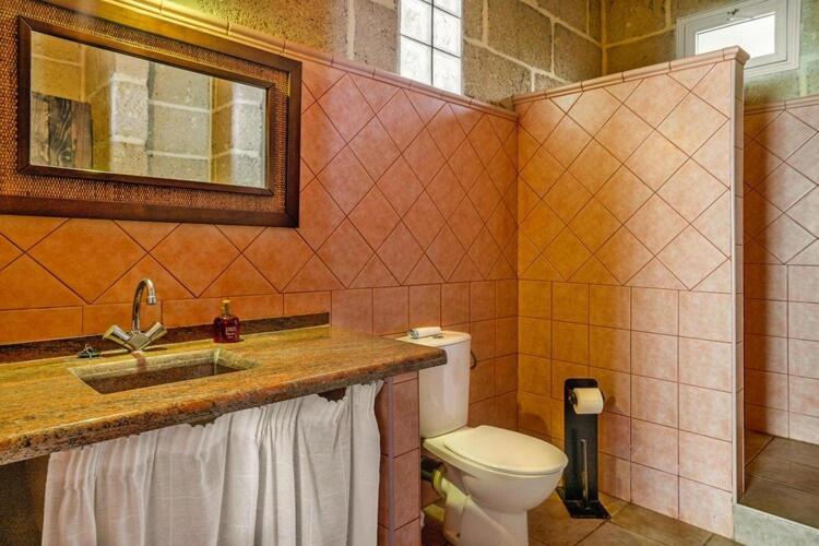 a bathroom with a sink and a toilet at Holiday home in Malpais de Candelaria with a terrace in Bence