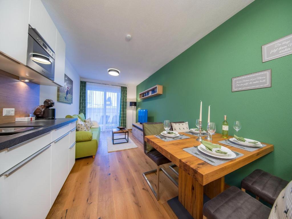 a kitchen and dining room with a wooden table at Apartment in the heart of Neukirchen in Neukirchen am Großvenediger