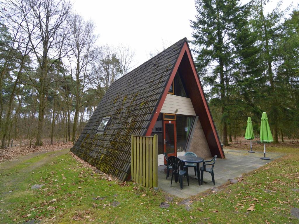 a small house with a table and chairs in front of it at Dine & Unwind Vacation Spot in Stramproy