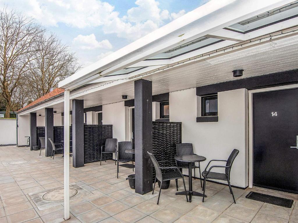 a patio with chairs and a table and a building at 3 person holiday park home in Give in Give