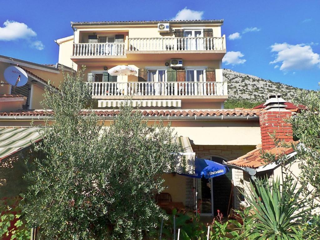 a large house with a balcony on top of it at Apartment Grande Vista in Starigrad Paklenica with a large terrace in Starigrad-Paklenica