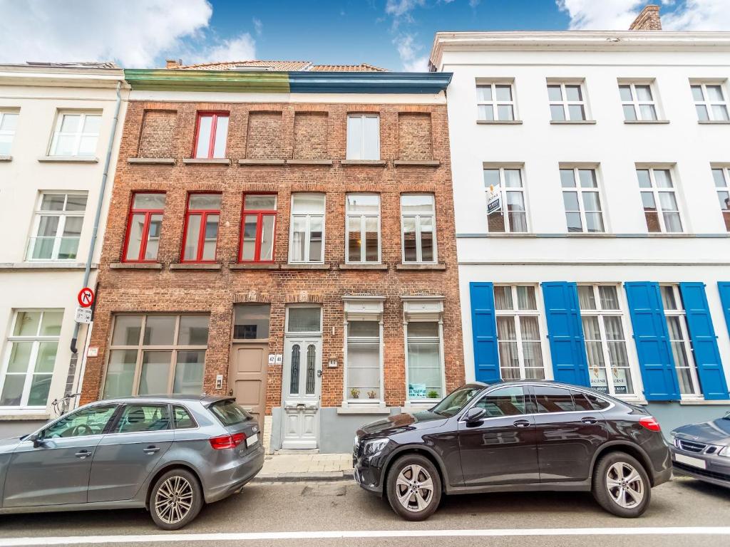 two cars parked in front of a building at Spacious holiday home in Bruges in Bruges