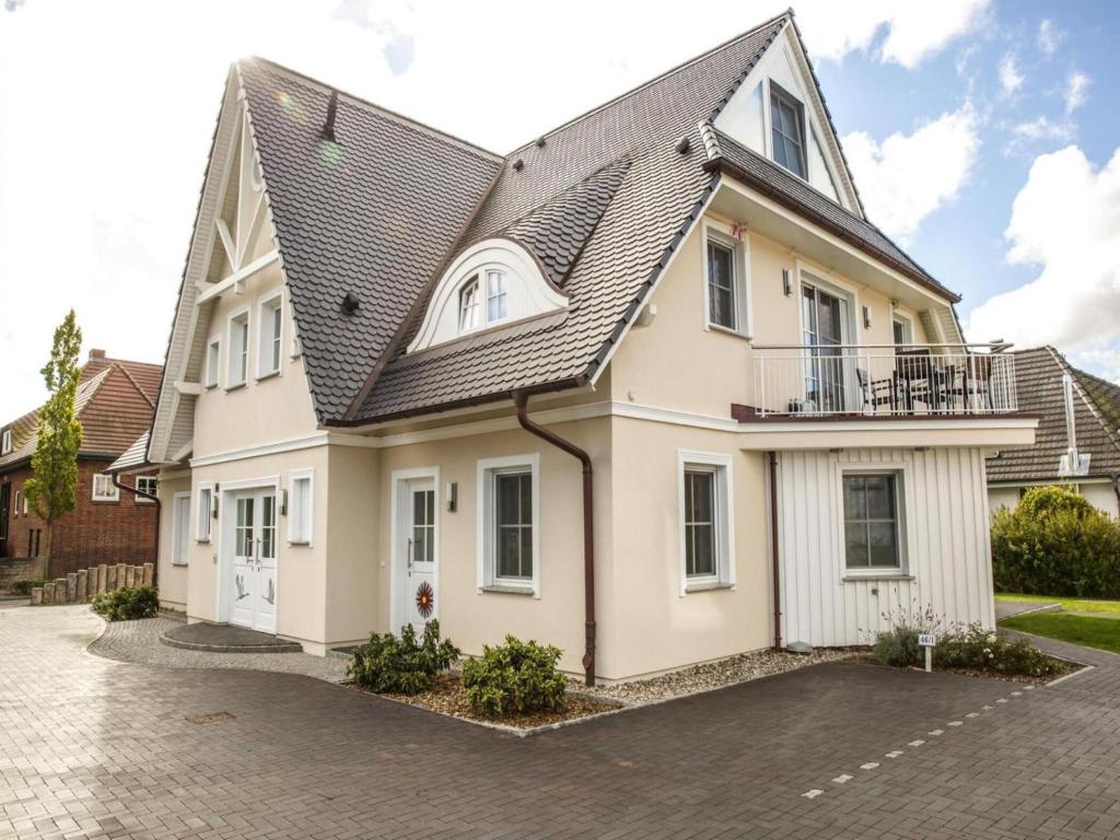a white house with a black roof at Apartment, Zingst in Zingst