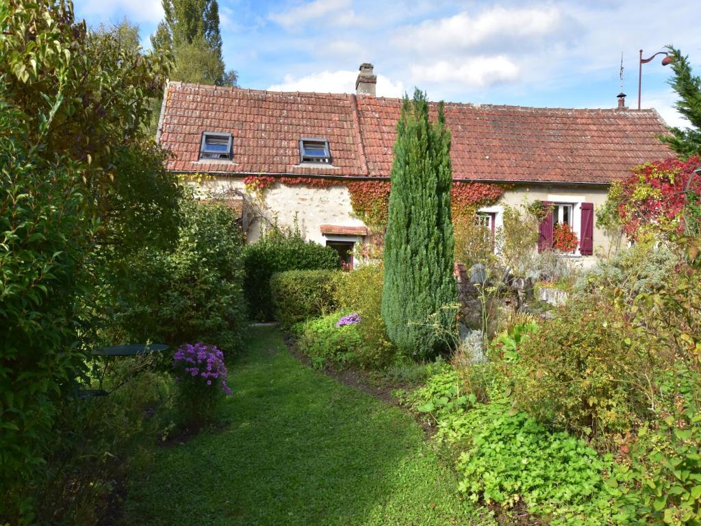 an old house with a garden in front of it at Charming Gîte in France for a Private Getaway in Mézy-Moulins