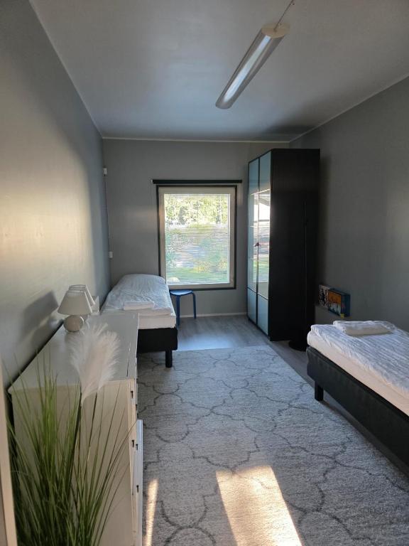 a room with two beds and a window at Your loft in Seinäjoki