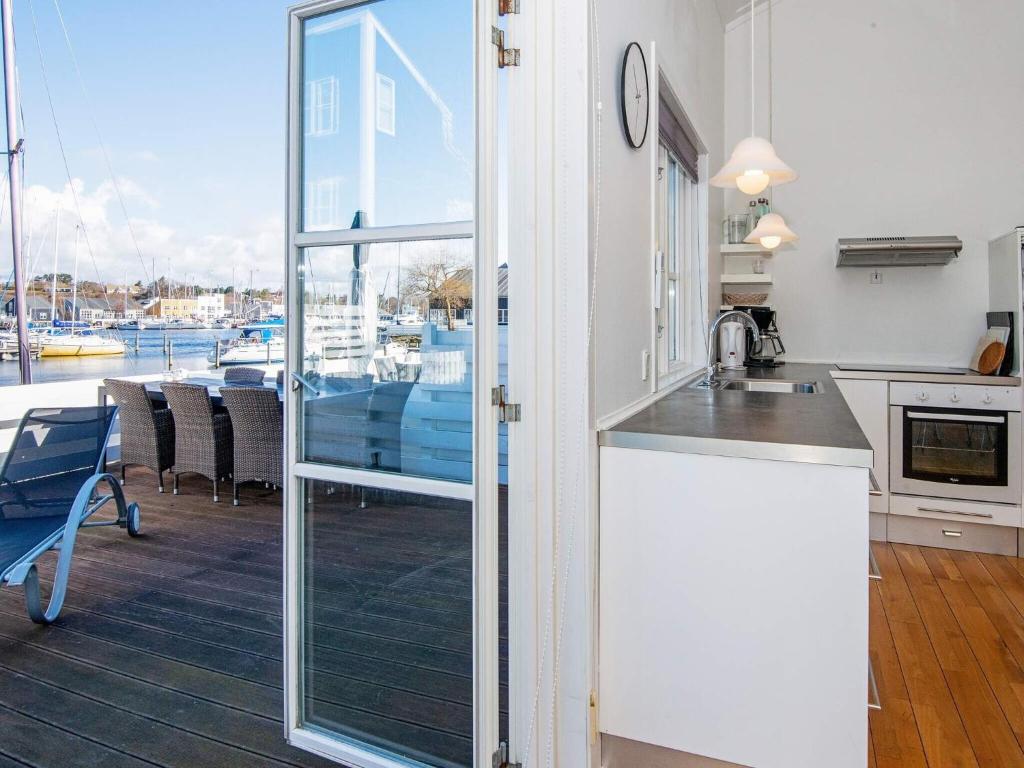 a kitchen with a view of a marina at Holiday home on a holiday park in Ebeltoft in Ebeltoft