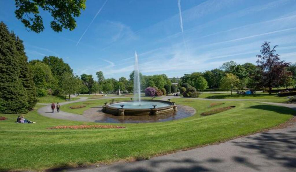 a fountain in the middle of a park at Double Deluxe Centre Apartment- Free Parking - Self Check-In - Cctv in Huddersfield