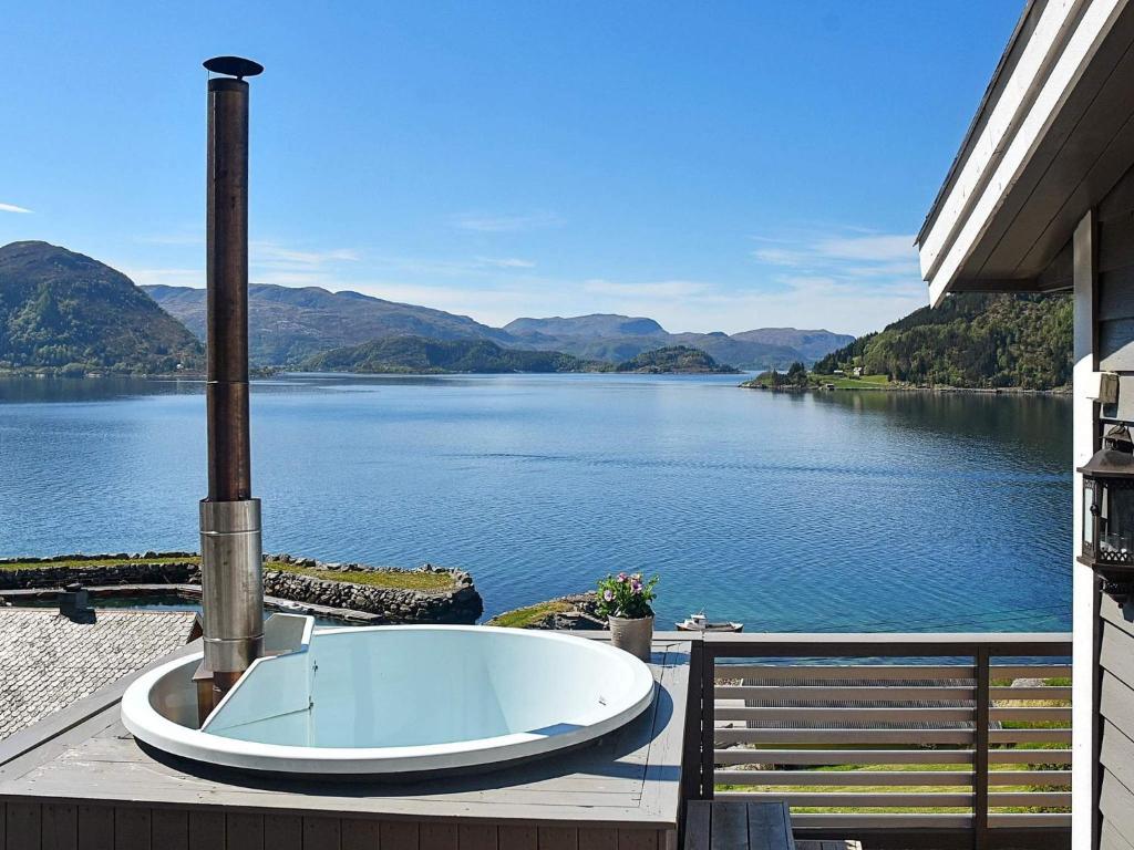 a bath tub sitting on a deck with a view of a lake at 4 person holiday home in Selje in Selje