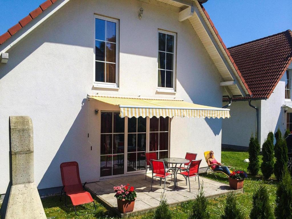 a table and chairs in front of a house at Ferienhaeuser am Kummerower See in Verchen in Verchen
