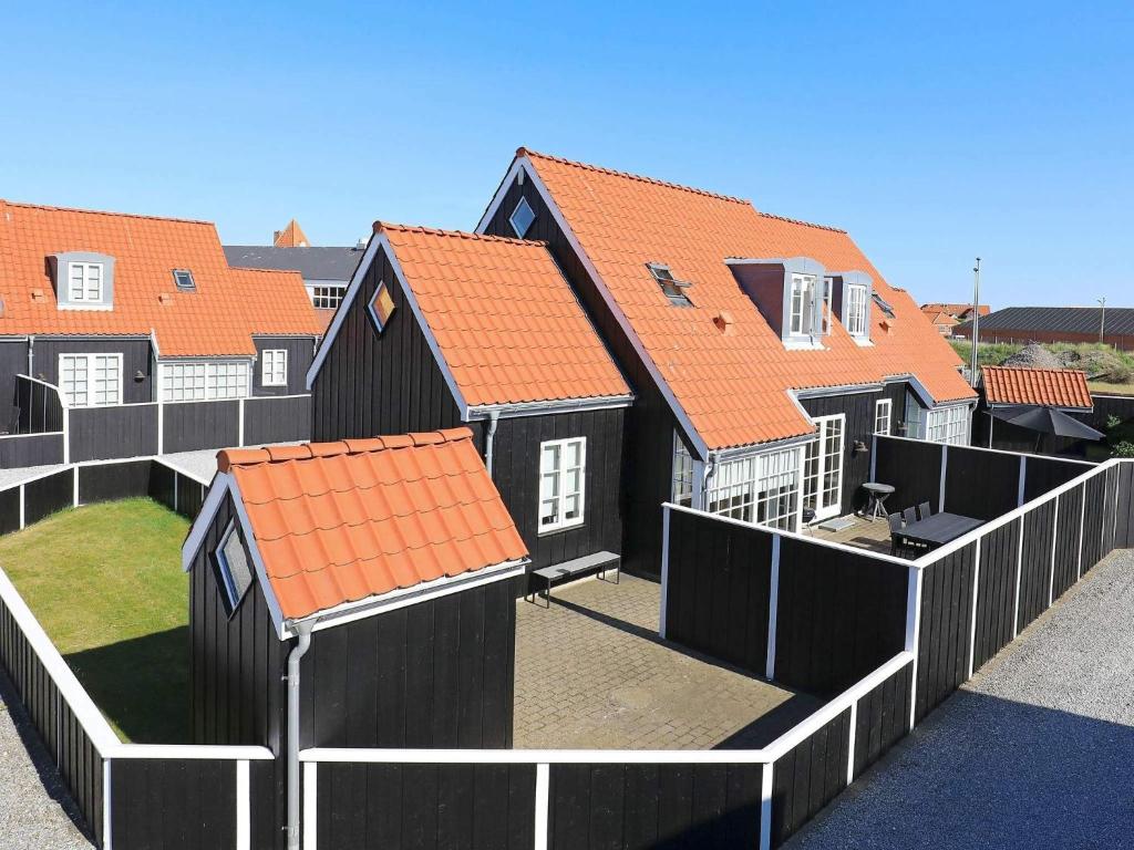 a row of houses with orange roofs at 6 person holiday home in Skagen-By Traum in Skagen