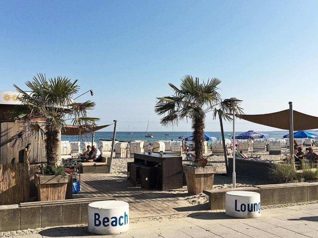 a beach with palm trees and the ocean at 5 star holiday home in Großenbrode in Großenbrode