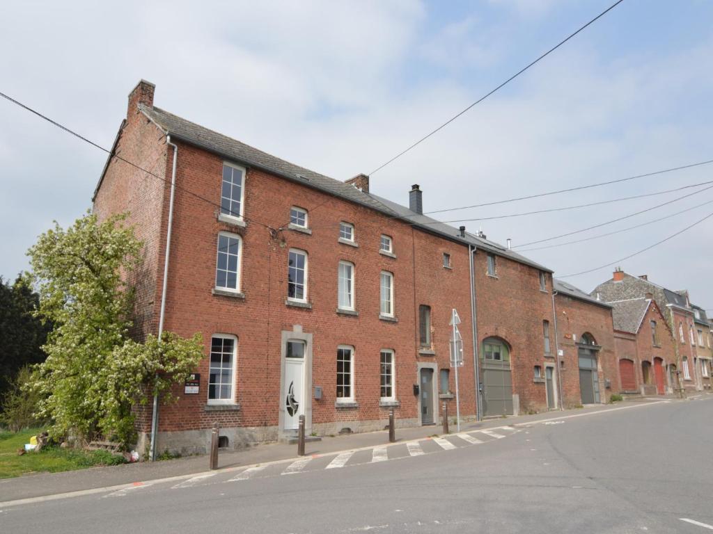 a large brick building on the side of a street at Stylish Duplex with Sauna in Modave