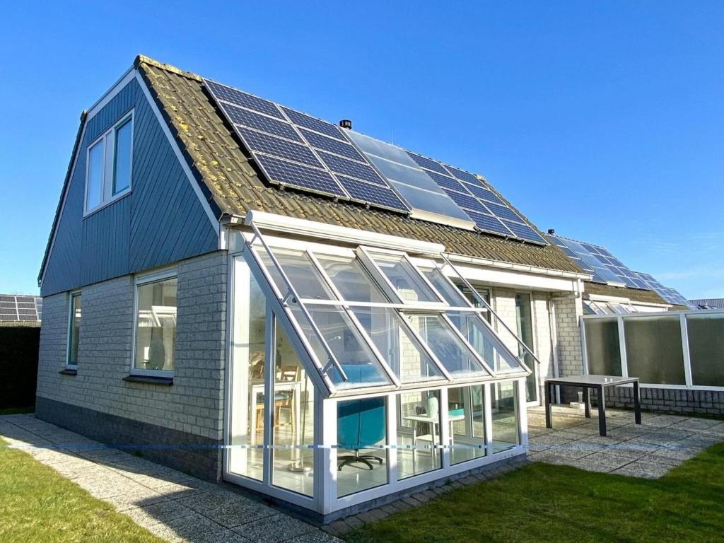 a house with solar panels on the roof at comfortable bungalow for 6 people, in Sint Maartenszee