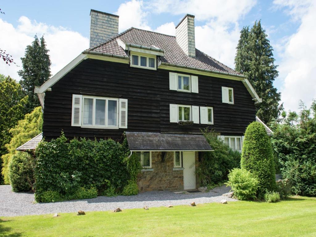 a black house with a gambrel roof at Mansion in Spa Liege with private garden in Spa