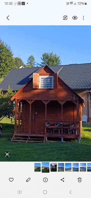 a large wooden pavilion with a window on top of it at Domki Tomek Bieszczady in Polańczyk