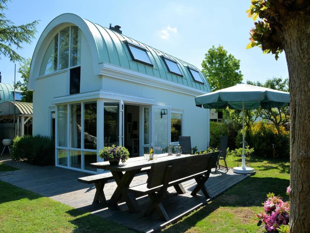 a house with a picnic table in the yard at Holiday Home in Noordwijk near the Beach in Noordwijk