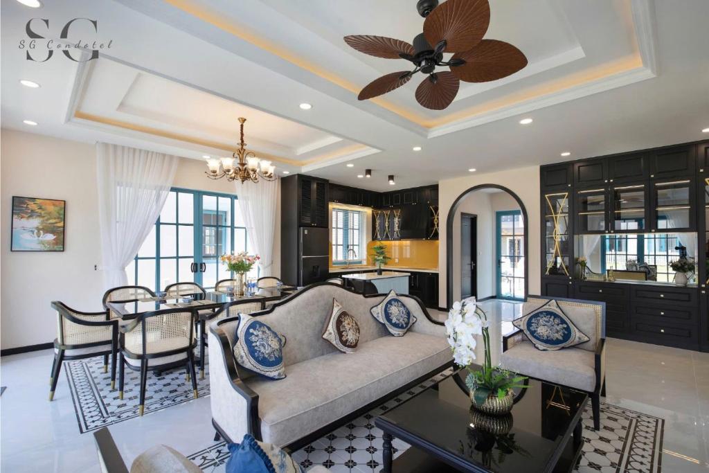 a living room with a couch and a table at Novaworld Phan Thiết - Ni Villa in Phan Thiet