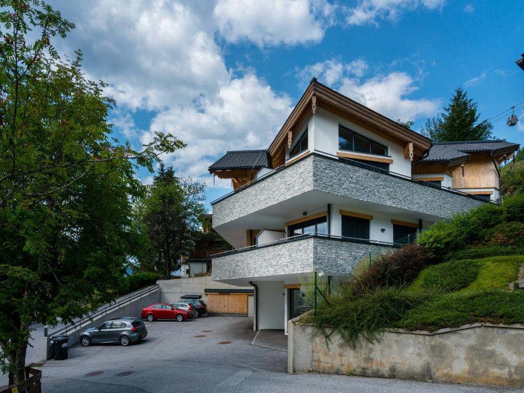 a building with cars parked in a parking lot at Chalet in Alpendorf near Ski Slopes in Alpendorf