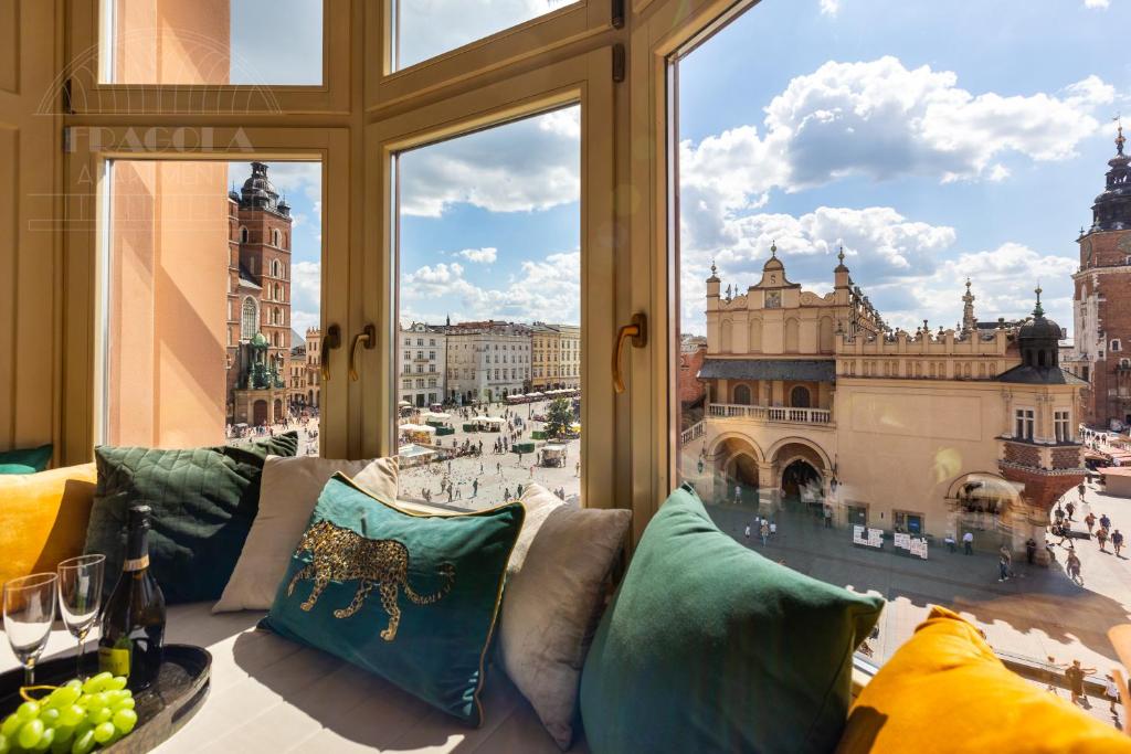 a room with a view of the city from a window at Feniks Main Square by Fragola Collection in Krakow