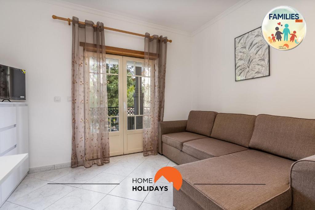 a living room with a couch and a window at #230 Only Families - Flat A Flor by Home Holidays in Vale de Pedras
