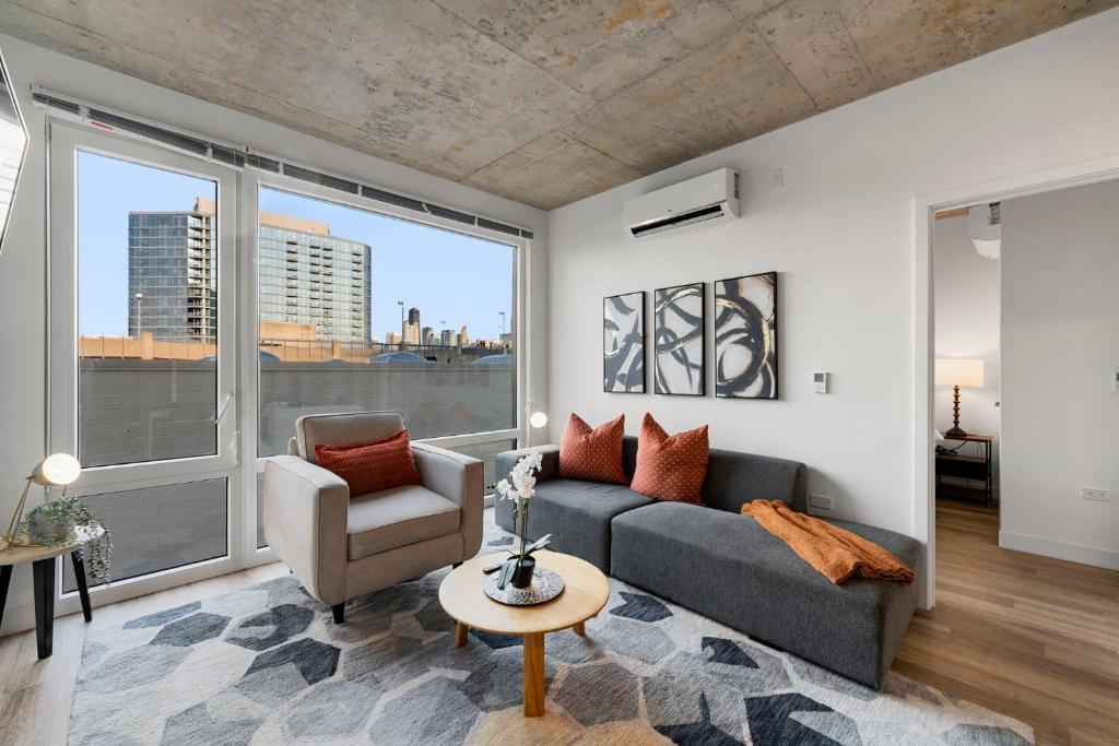 a living room with a couch and a chair at Corporate-Friendly 4BR Stylish & Central in Chicago