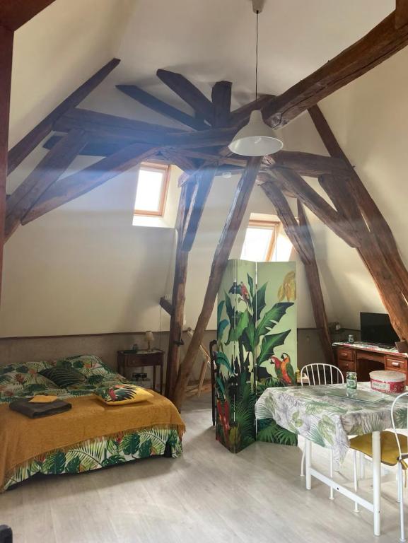a bedroom with two beds and a ceiling fan at Cœur de Loire in Nevers