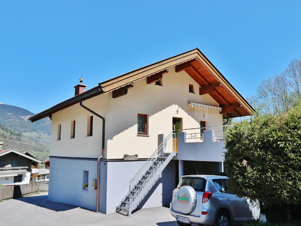 a house with a car parked in front of it at Apartment in Niedernsill near Ski Slopes in Niedernsill