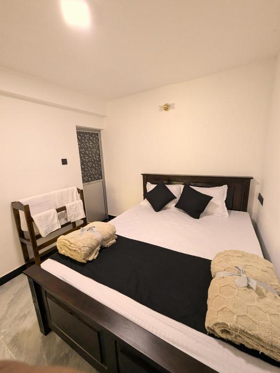 a bedroom with two beds with pillows at Willow Stay Ella in Ella