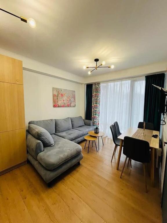 a living room with a couch and a table at Bakuriani Bliss Apartment in Bakuriani