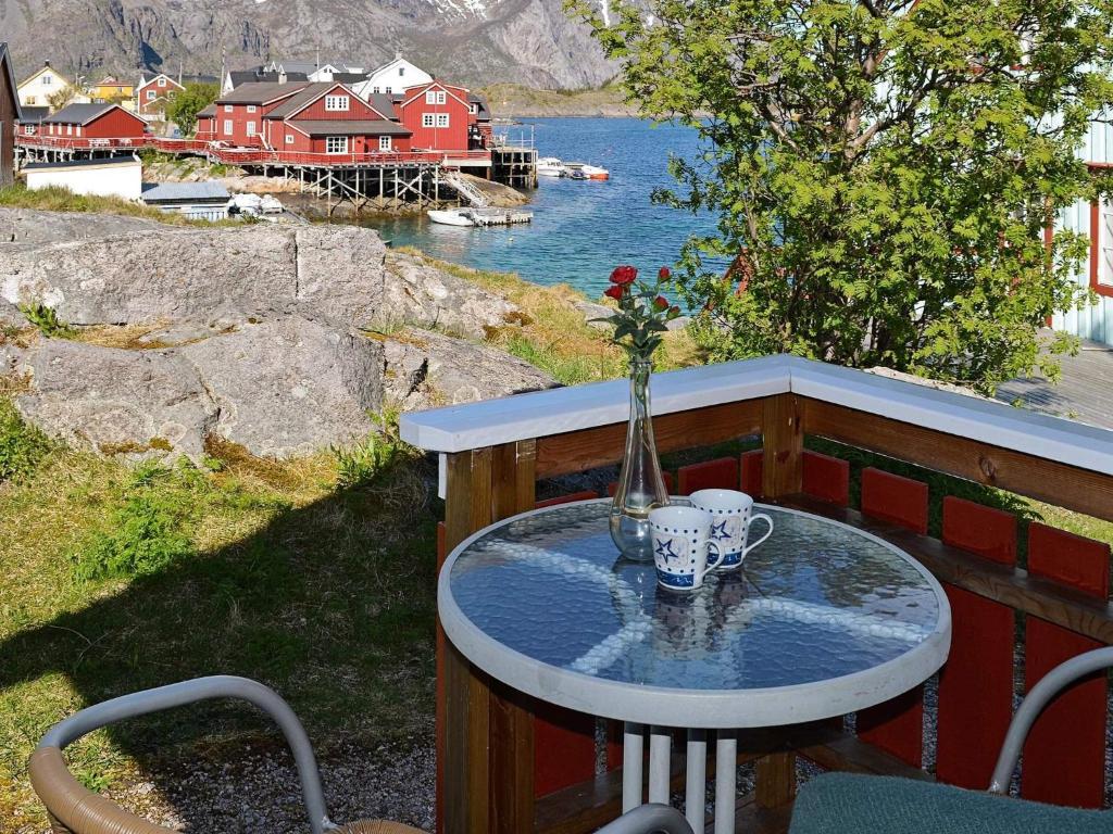 a table with a vase on top of a balcony at 3 person holiday home in Henningsvær-By Traum in Henningsvær