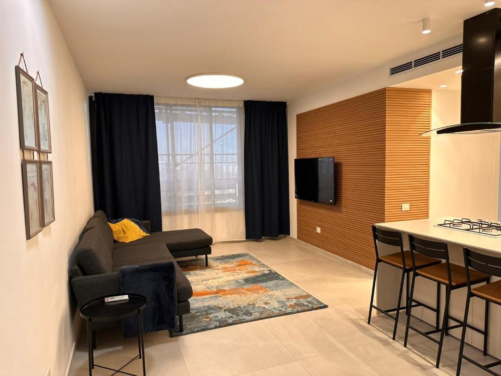 a living room with a couch and a bar at Family Friendly 3BR with Free Parking - in Rishon Letzion in Rishon LeẔiyyon