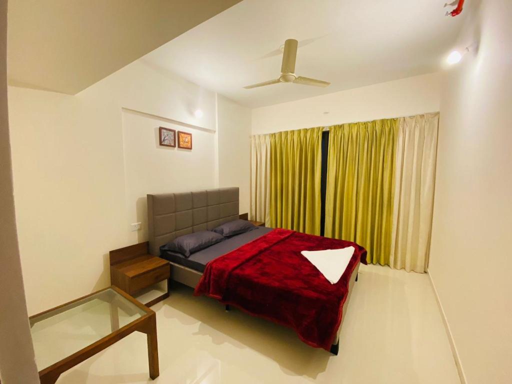 a bedroom with a bed and a ceiling fan at Petal Stay coliving in Pune
