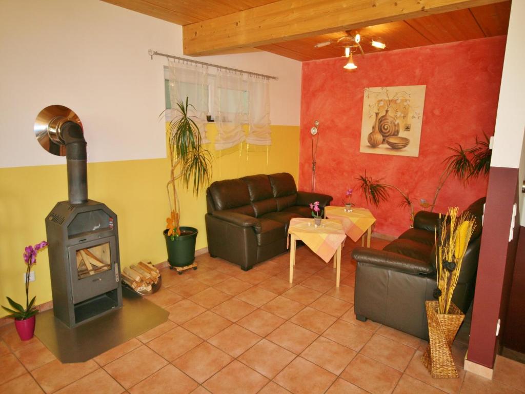 a living room with a wood stove and a couch at Chalet in Fürth near Zell am See Ski Slopes in Piesendorf
