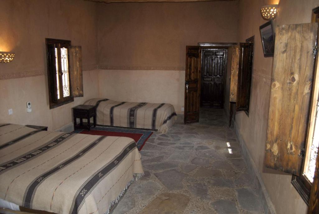 Postel nebo postele na pokoji v ubytování Kasbah Imdoukal