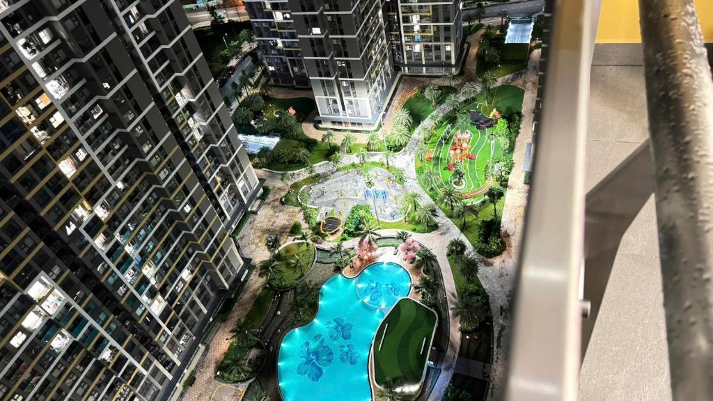 an aerial view of a swimming pool in a park between two tall buildings at The Place- Vinhome Grand Park Q9 in Long Bình